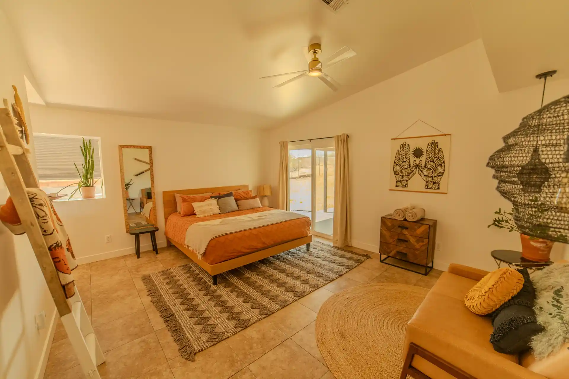 Cozy guest bedroom with warm desert-inspired decor, comfortable bedding and natural furnishings at Camp Vortex Retreats.